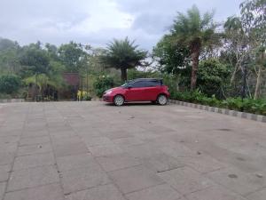 a red car parked in a parking lot at Kap Korome Village Resort in Koroth