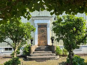 a wooden door with stairs in front of a building at 5:ans Bed & Breakfast in Gothenburg