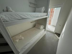 a room with two bunk beds and a window at Apartamentos en la rambla in Sant Feliu de Guíxols