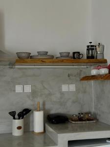 a shelf with bowls and other items on it at Errika's Sweet Home in Provatas
