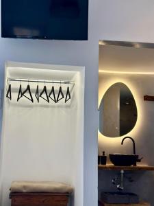 a bathroom with a sink and a mirror at Errika's Sweet Home in Provatas