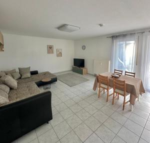 a living room with a couch and a table at Ferienwohnung Kornotti in Wimbach
