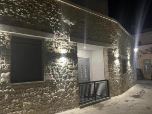 a stone wall with a television on the side of a building at Arianna's House in Ierapetra
