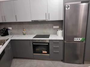 a kitchen with a stove and a refrigerator at Arianna's House in Ierapetra +3 photos