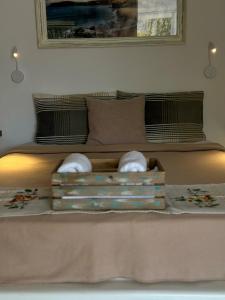 a bed with two towels in a box on it at Errika's Sweet Home in Provatas