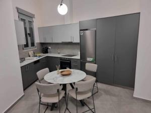 a kitchen with a table and chairs and a refrigerator at Arianna's House in Ierapetra
