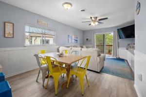 a dining room and living room with a table and chairs at Family Friendly 2BR Condo with Large Balcony, Partial Ocean Views in Ocean City