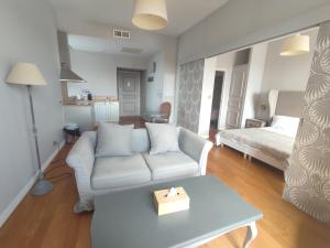 a living room with a couch and a bed at La Redorte Appartement au château 8 in La Redorte