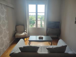 a living room with a couch and a table at La Redorte Appartement au château 8 in Laredorte