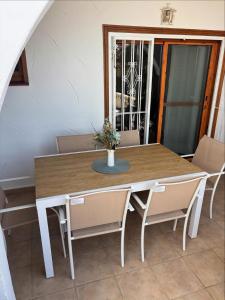 a dining room table and chairs in a room at CasasQuesada in Ciudad Quesada