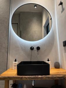 a bathroom with a black sink and a mirror at The Prut Lodge in Vorokhta +53 photos