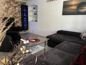 a living room with a couch and a glass table at Âme de la nature in Nedeščina