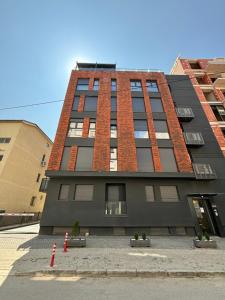 a tall black building with a lot of windows at City Center Apartment 2 in Skopje