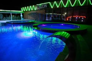a pool with blue and green lights in a building at Коттедж in Koshkolʼ