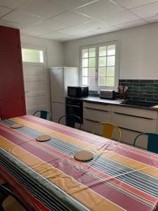 a kitchen with a table with a table cloth on it at Maison familiale au calme in Saint-Pée-sur-Nivelle +6 photos