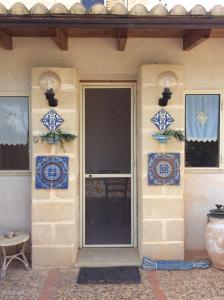 una porta d'ingresso di una casa con piastrelle blu e bianche di Favignana Vacanze a Favignana
