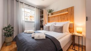 a bedroom with a large bed with two pillows on it at Flatbook Apartamenty - Trimare II Sztutowo z bilardem i parkingiem in Sztutowo