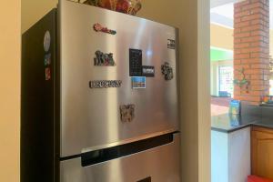 a stainless steel refrigerator in a kitchen with magnets at Acogedora casa en Cartagena Colombia cerca a zonas turísticas in Cartagena de Indias