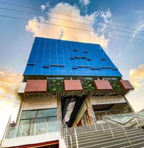 a tall building with blue glass panels on it at Apartamento 107 Hotel Novo Centro in Petrolina
