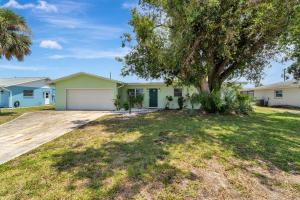 a house with a tree in a yard at 2 Kitchens, Pool, Ping Pong, Corn Hole, BBQ in Venice