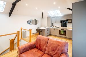 a living room with a couch and a kitchen at Town Center Duplex 6 in Harrogate