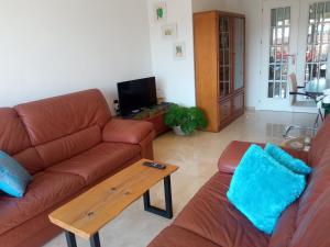 a living room with a couch and a coffee table at ELIO Murcia El Carmen in Murcia