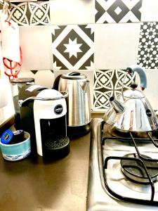 a kitchen counter with a coffee maker and a toaster at Casa Malù, Corso Italia Piombino AC in Piombino