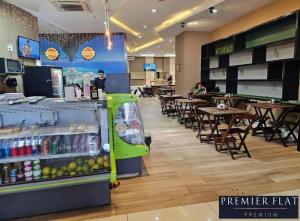 a restaurant with a cash register and tables and chairs at Premier Flat Premium Queimados in Queimados