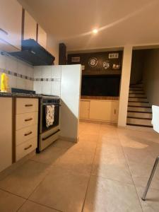 a kitchen with a stove and a staircase at Jardín del Mar in Playa Unión