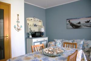 a dining room with a table with a bowl of food on it at Summer House in Buonfornello