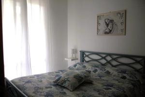 a bedroom with a bed with a pillow on it at Summer House in Buonfornello