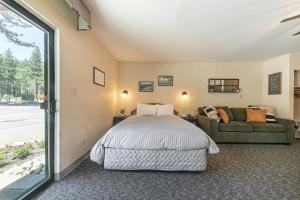 a bedroom with a bed and a couch at 134 Bldg C studio in Truckee