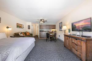 a bedroom with a large bed and a kitchen at 134 Bldg C studio in Truckee