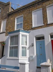 a brick house with a blue door and windows at Ramsgate Family Cottage nr Beach -Harbour- Sleeps 4 - Garden - Parking on Street in Ramsgate
