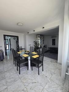 a dining room with a table and black chairs at Luxury Apartment with private pool and 2 bedrooms in Villa Opatija Bay View in Opatija