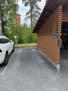 a car parked in a parking lot next to a building at Apartment in Kuopio's Archipelago City in Kuopio +10 photos