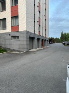 a parking lot in front of a building at Apartment in Kuopio's Archipelago City in Kuopio