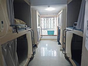 深圳Kuaike Xingjiduo Apartment的走廊上设有双层床,位于带窗户的房间内