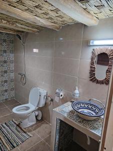 a bathroom with a toilet and a sink at DAR JOUD in Tabourakht +41 photos