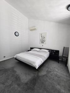 a bedroom with a large bed and a chair at Luxury Apartment with private pool and 2 bedrooms in Villa Opatija Bay View in Opatija +19 photos