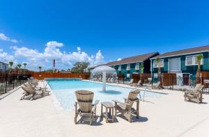 a swimming pool with chairs and an umbrella at B6 Little Bay Landing Long Term in Rockport