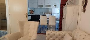 a living room with a couch and a kitchen at Apartments Cinderella with City View in Mostar