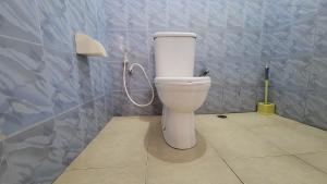 a bathroom with a white toilet in a room at Milele Homestay in Boma la Ngombe +30 photos