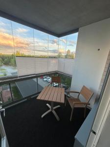 a balcony with a bench and a table and chairs at Apartment in Kuopio's Archipelago City in Kuopio