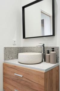 a bathroom counter with a sink and a mirror at Suite sensuelle et balnéothérapie in Nemours +32 photos