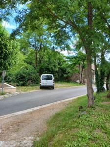 a white van parked on the side of a road at cosy logis et son écrin de verdure in Cordes-sur-Ciel +1 photo