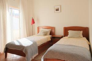 a bedroom with two beds and a window at Charming Lagos Stay - Walk to Beach & Historic Centre in Lagos
