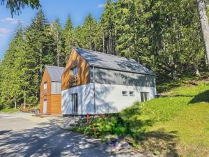a barn with a wooden house in the woods at Chalet La Martina in Zuberec