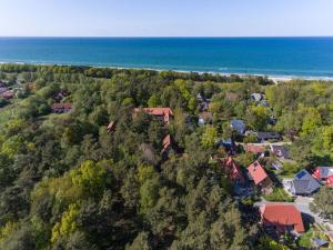 an aerial view of a house and the ocean at Holiday home in Zingst with swimming pool in Zingst