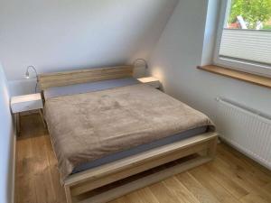 a small bed in a small room with a window at Holiday home in Zingst with swimming pool in Zingst